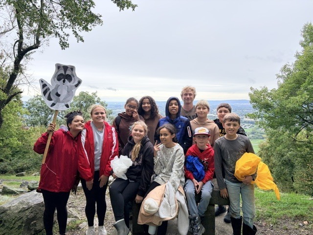 students smiling for picture at top of the hike