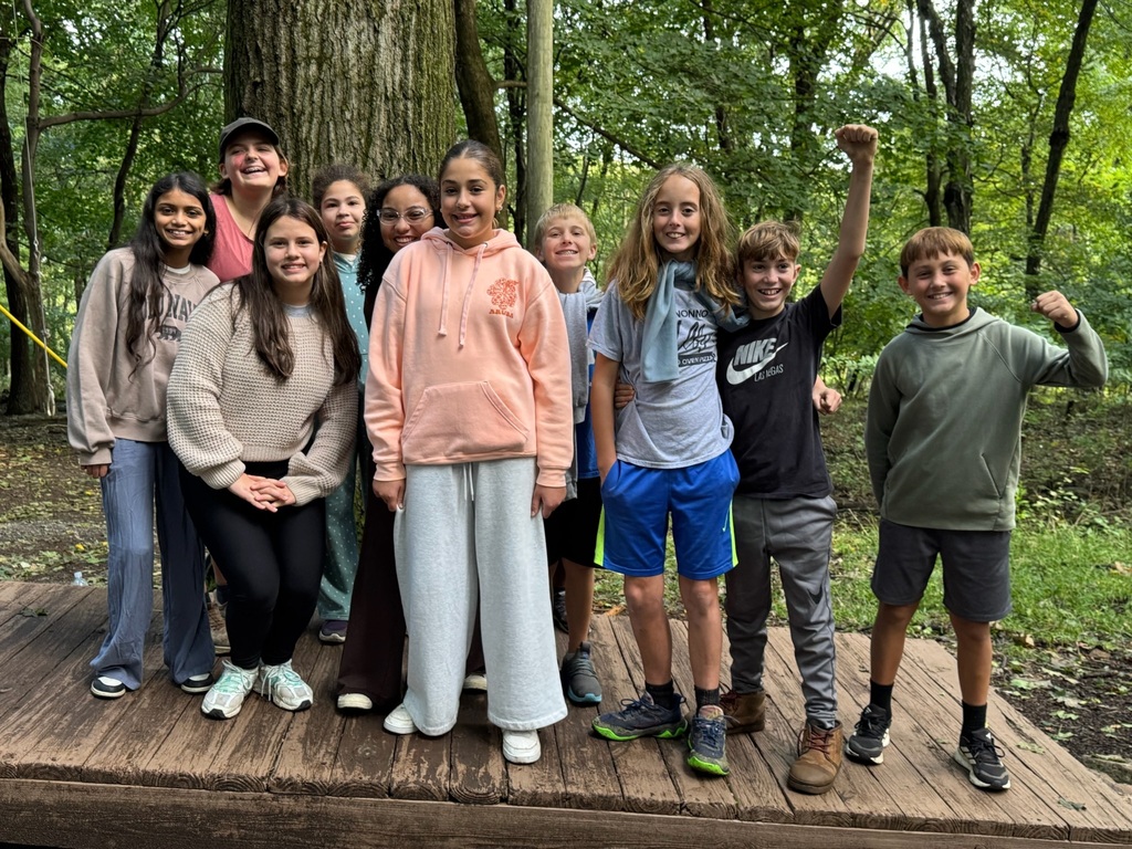 students smiling standing on wooden board