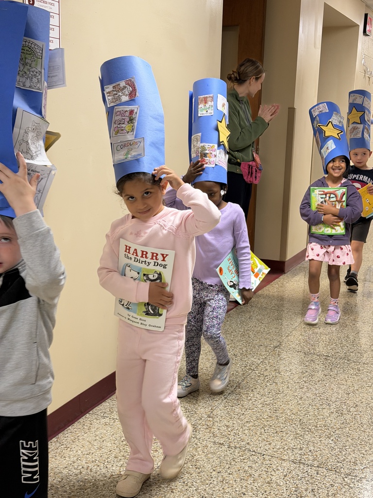 students carrying books with reader caps on