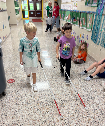 students practing using white canes