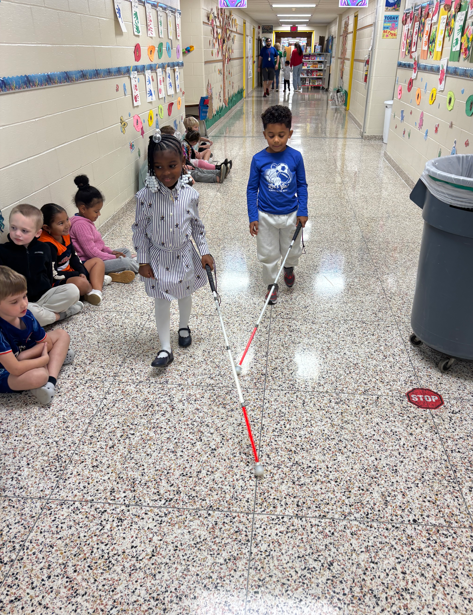students practicing using canes