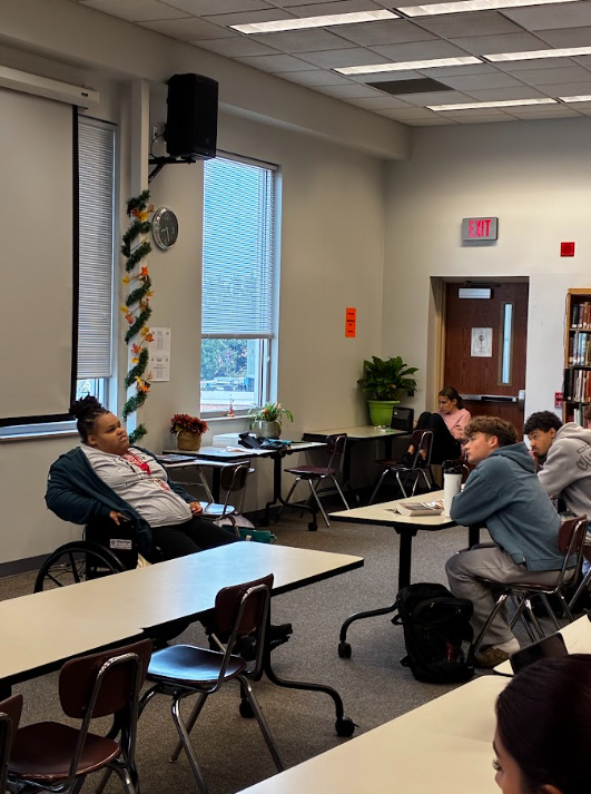 student in wheelchair in front of class talking about white cane day