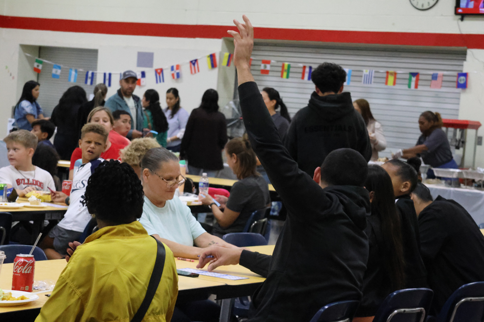 person raising hand for bingo