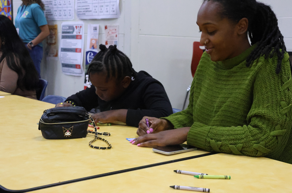 two people playing bingo using crayons