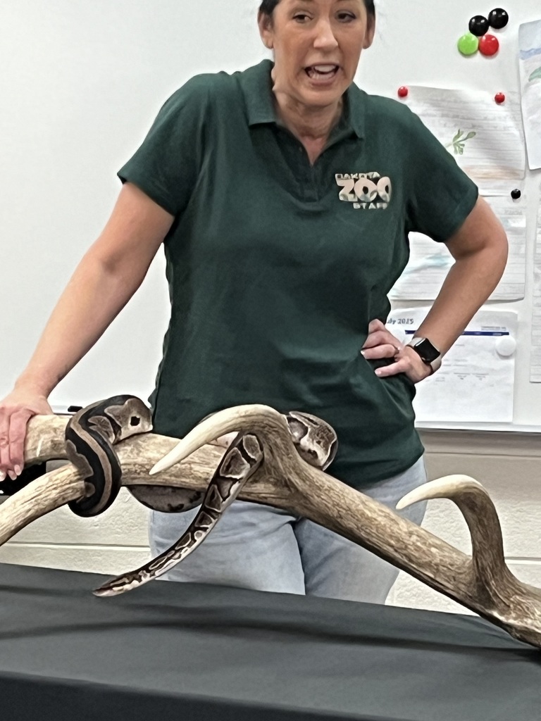 Listening to the lady from the zoo talk about a snake.