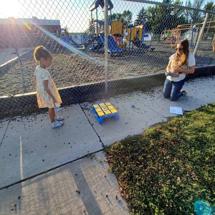 Adult and child playing Bean Bag Tic Tac Toe