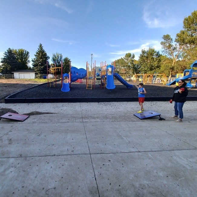 Adult and child playing Cornhole