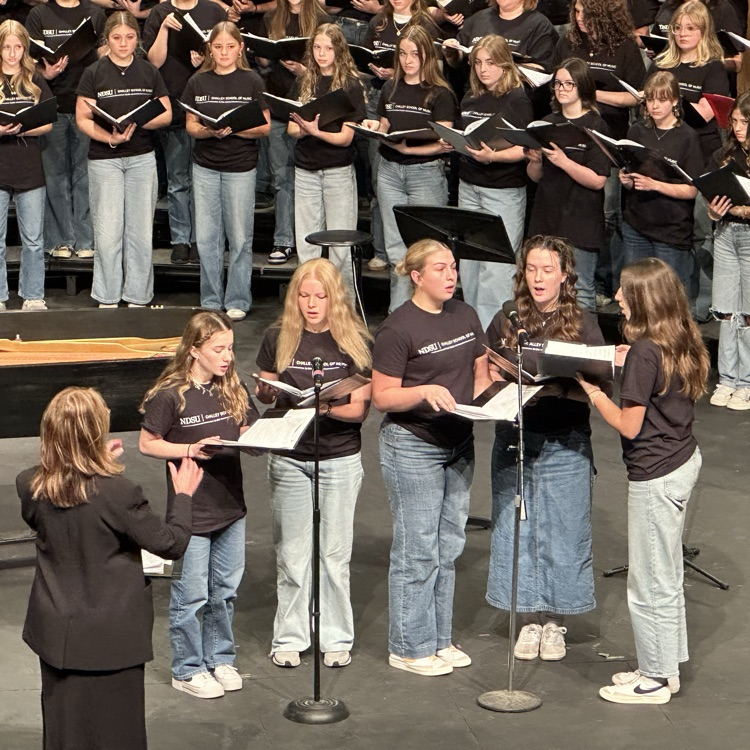 Raina singing with small group