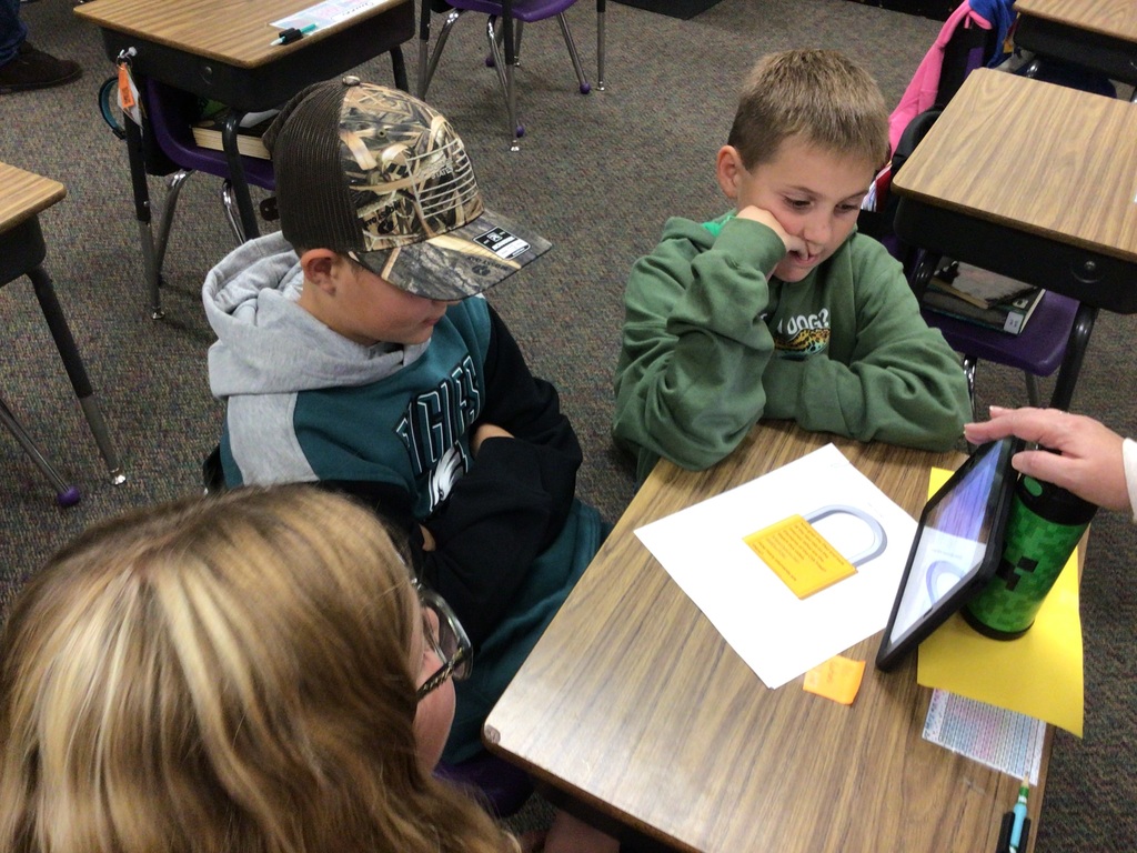 kids watching a video on an iPad