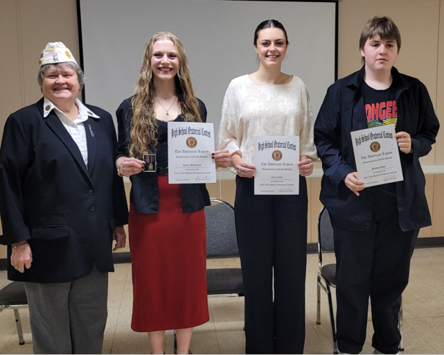 Picture of people holding award certificates