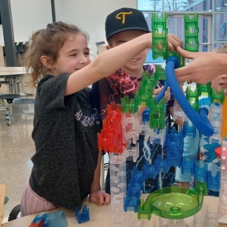 Kids building a marble run.
