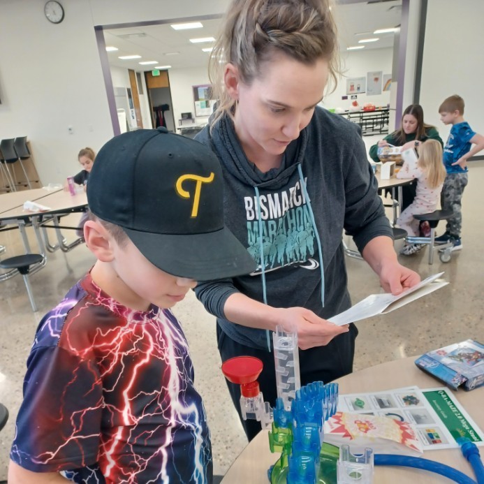 Mom & kid building a marble run.