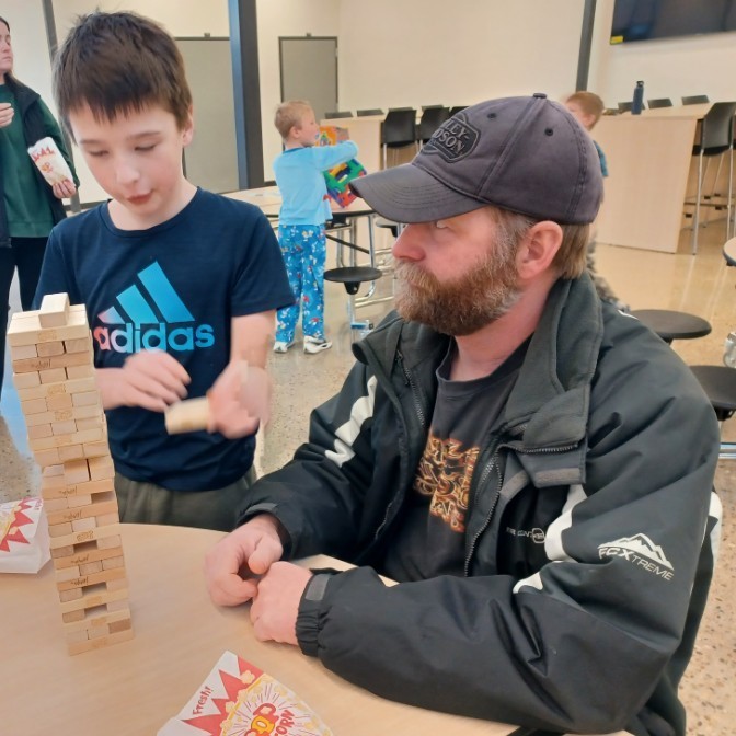 Dad & son playing Jenga.