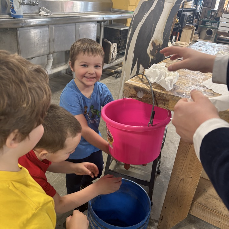 pretending to milk a cow