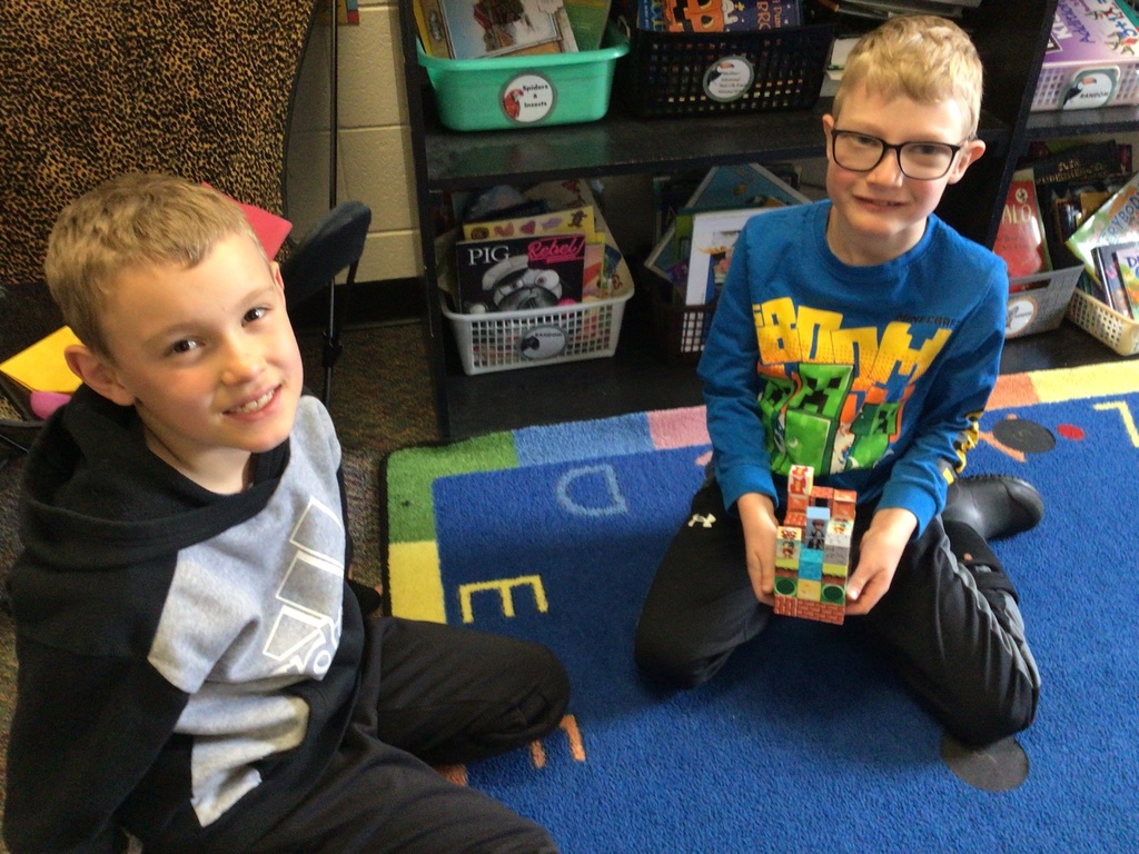 2 boys showing their Minecraft creation