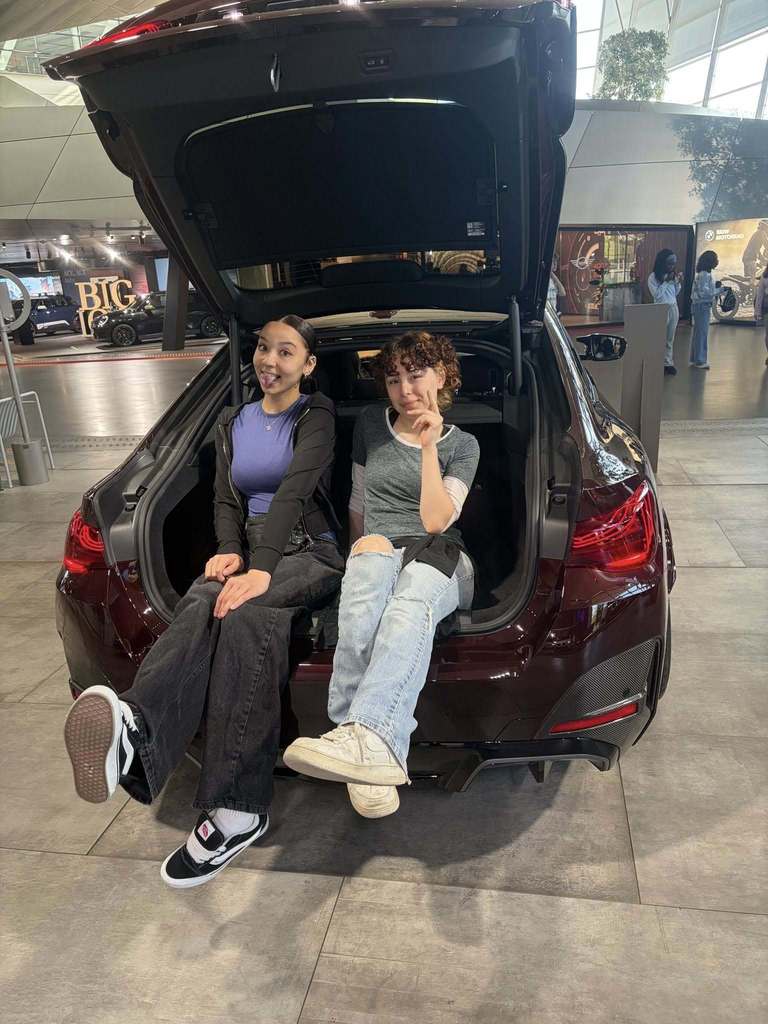 students sitting in trunk of car