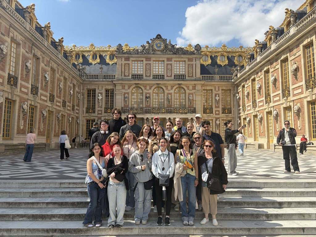 group of students in front of castle