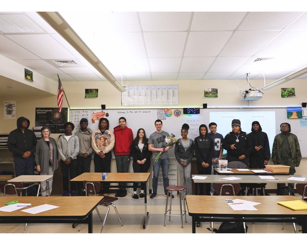 Joseph Oblon's class is posing for the picture with him