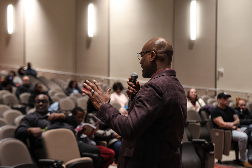 Dr. Parker, High School Principal, is addressing the audience