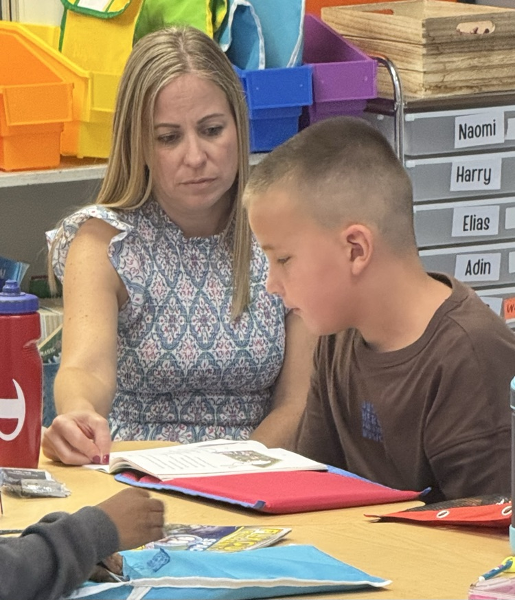 student and teacher reading