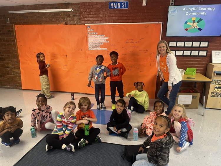 students signing unity day pledge in hallway