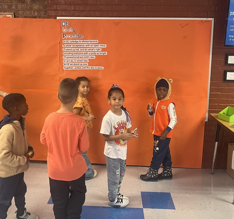 students signing unity day pledge in hallway