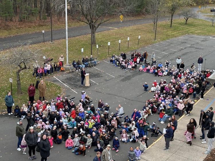 picture from roof of OE staff and students in parking lot for Veterans Day