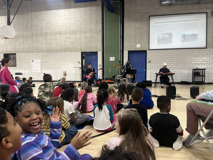 students watching blues and beyond performers in gym