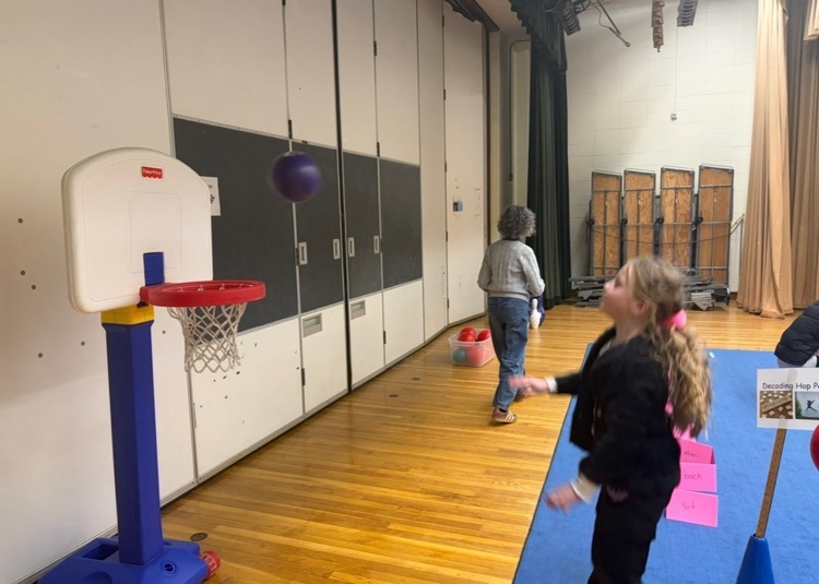student shooting a ball into hoop