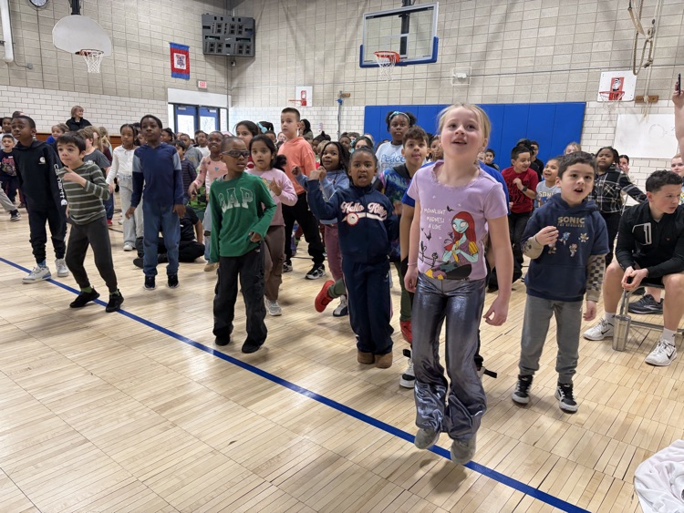 students in the gym jumping during movement break