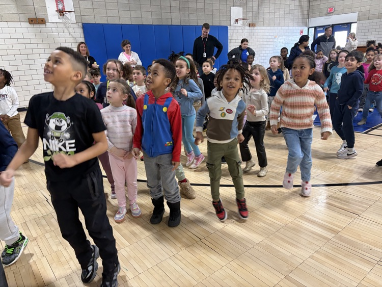 students in the gym jumping during movement break