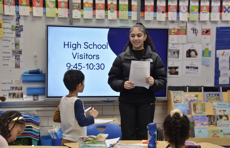 high school visitor reading to class 