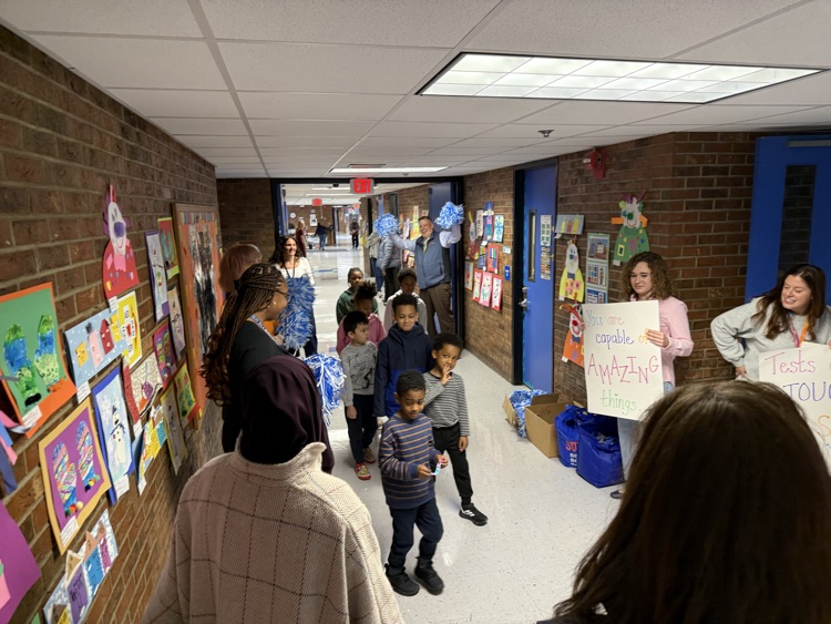 staff cheering for students as they enter the gym 