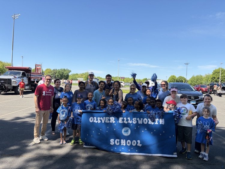 OE students and families holding banner 