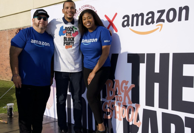 dr. Mallery is posing for a picture with Amazon emlpoyees