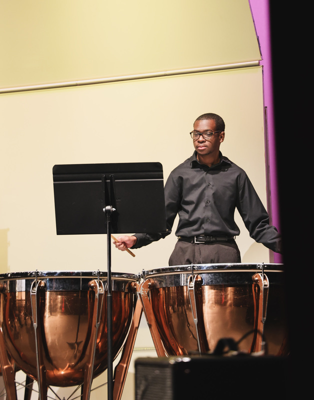 A student is playing drums