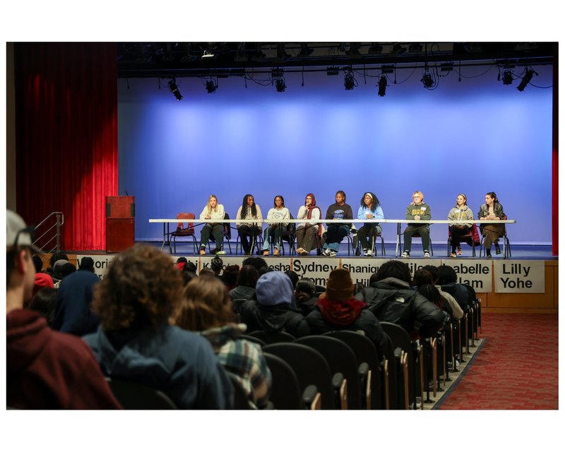 audience is listening to the speakers on the stage
