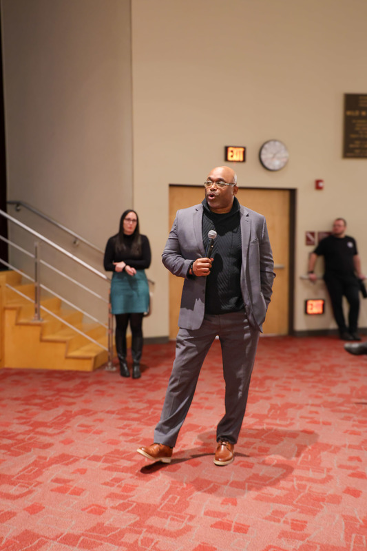 The head of athletics presenting on school's athletic programs and requirements, as well as values