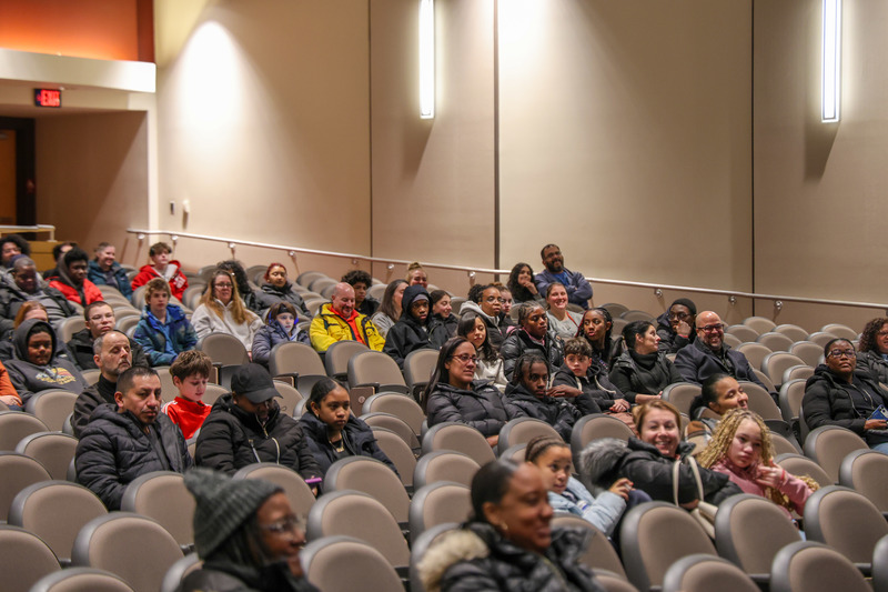 Audience members listening to a presentation