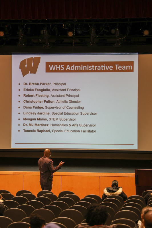 Dr. Parker stands in front of a presentation slide outlining WHS Administrative Team