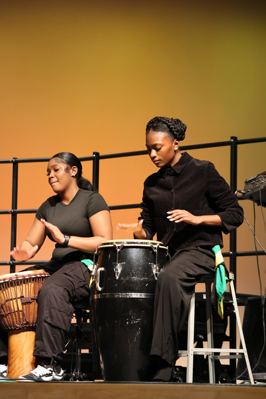 2 girls are playing drums