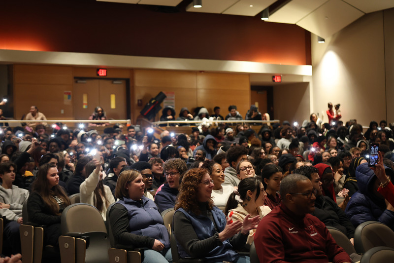 The audience is supporting performers with flashlights