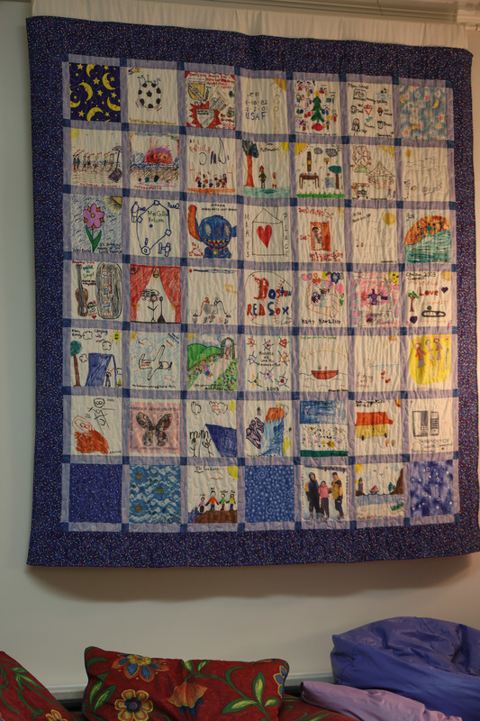 A quilt blanket that has things important to Mary's Place visitors