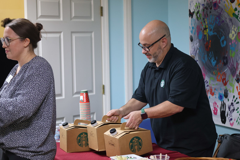 Starbucks manager pouring coffee to guests