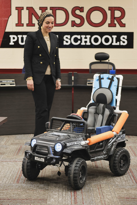 Dr. Hady is looking at the go baby go car upclose