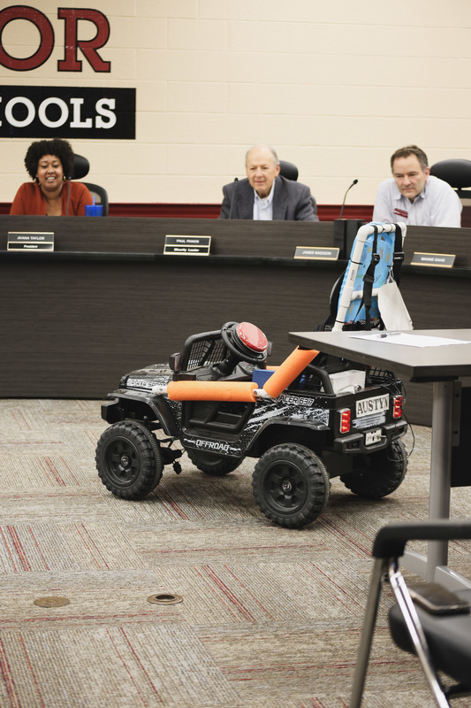 go baby go car is being driven in front of the BOE members