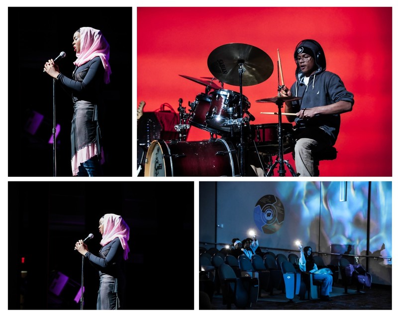 A student singing with passion, another student is drumming. The audience is supporting the by holding up flashlights