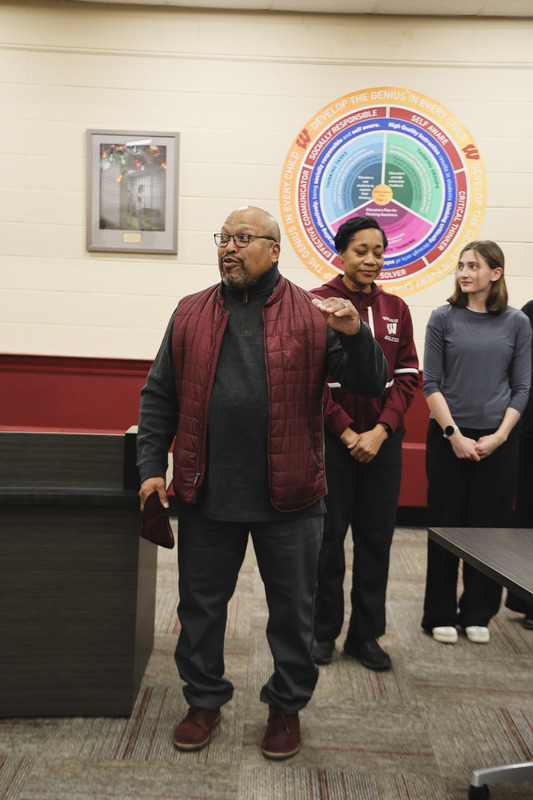 Firl's track coach is giving a speech about the team's performance. 