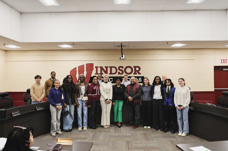 Girl's track team is taking a picture with the BOE, coaches, and Acting Superintendent.