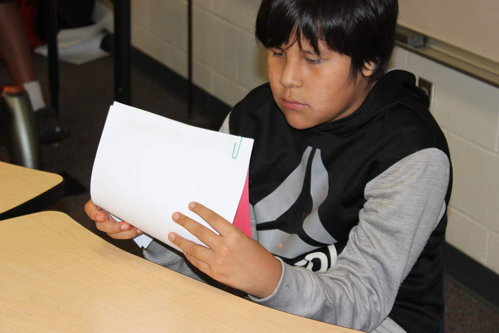Student holding up their paper